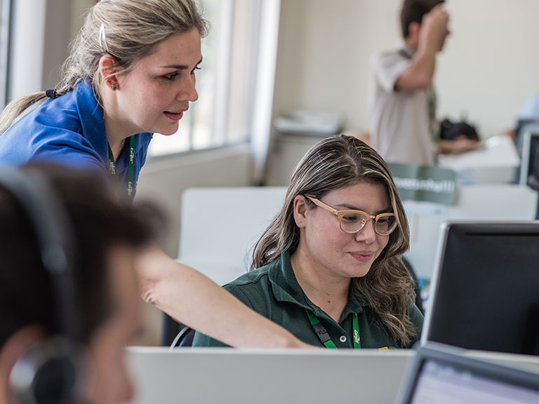 Two women working together at computer